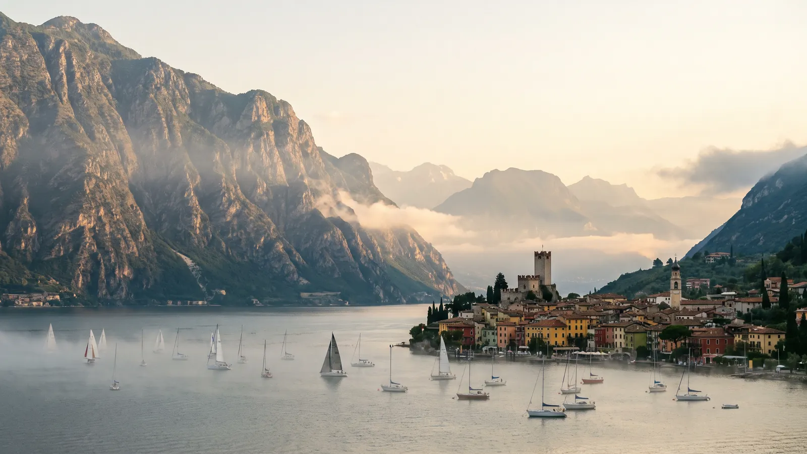 Gardasee mit Bergen und Ortschaft am Ufer